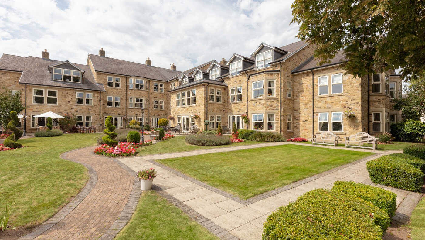 Exterior view of the Mill View facility with landscaped garden