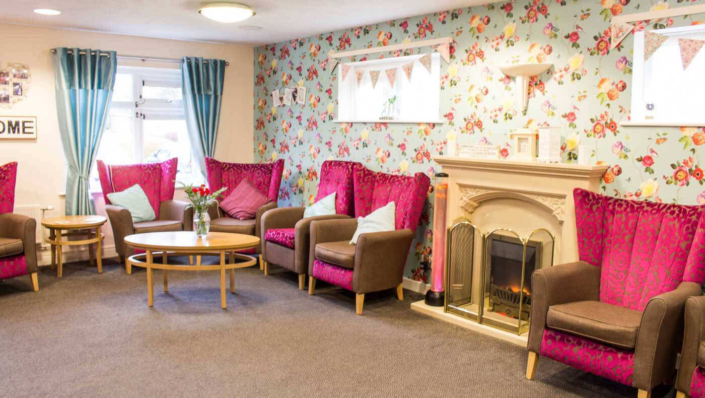 Bright common area with floral wallpaper and comfortable seating
