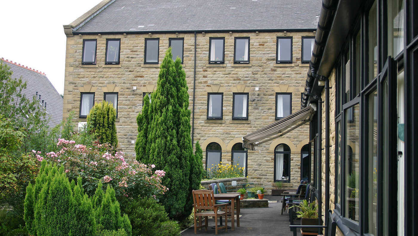 Exterior view of Mill View facility with garden area