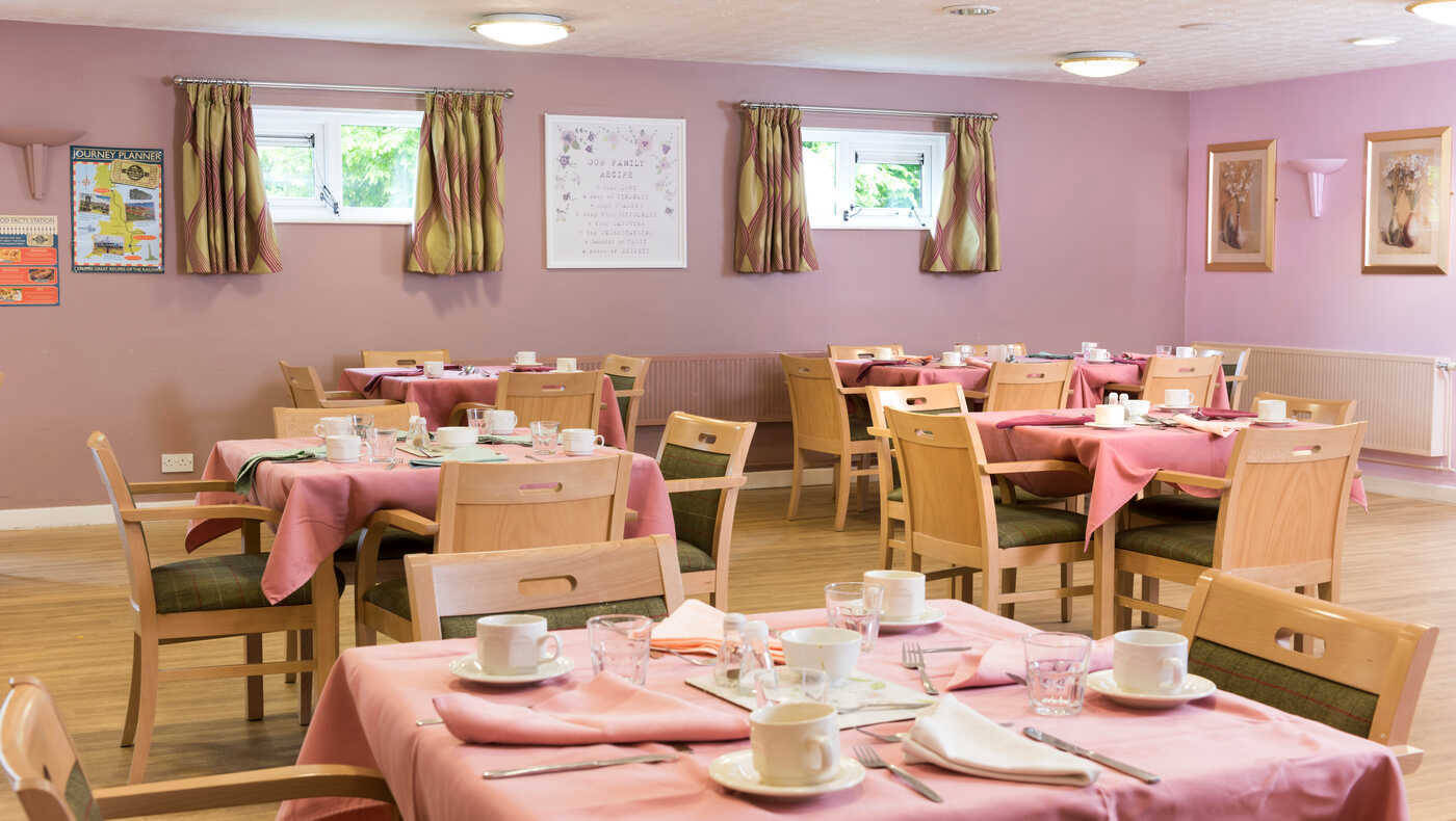 Dining room setup with tables and dishes