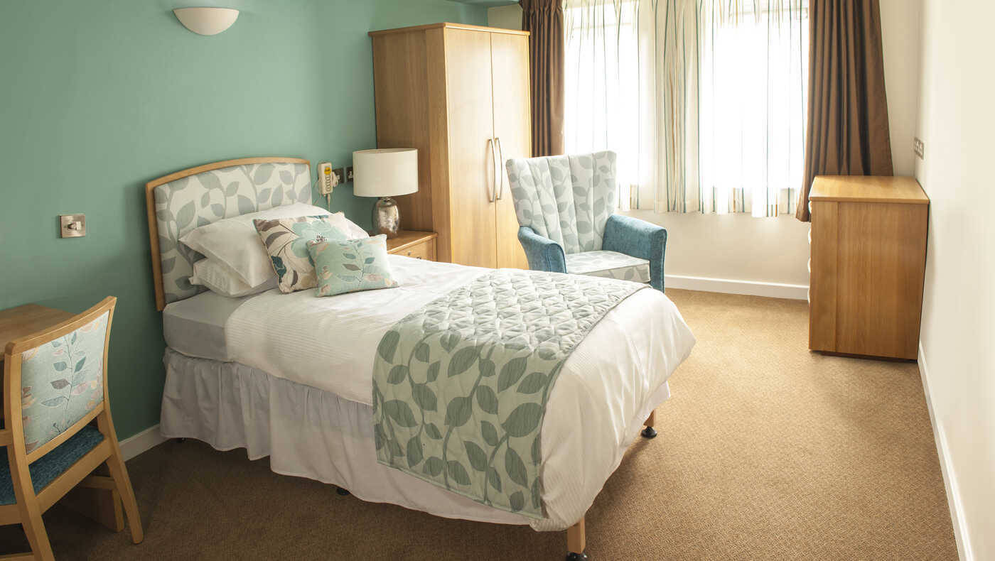 Cozy private resident room with bed and seating