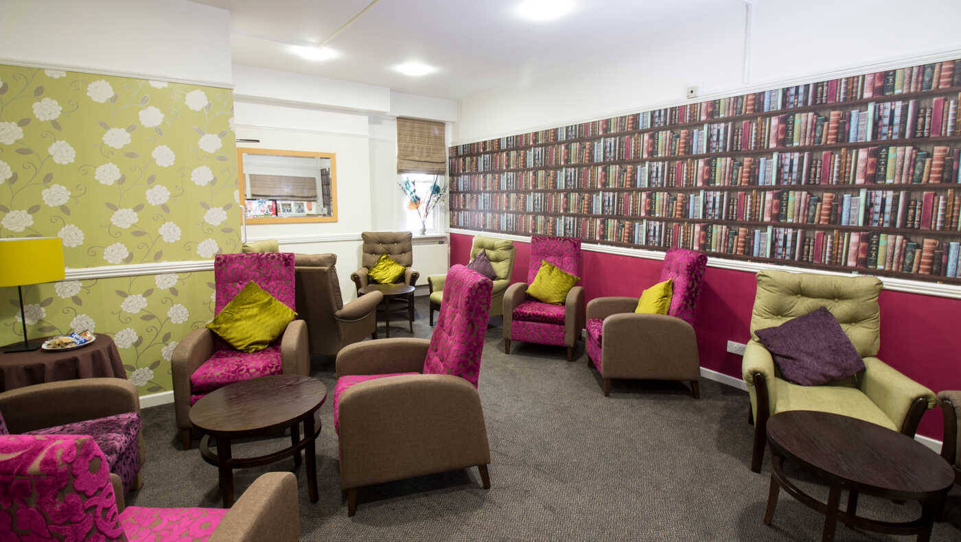 A cozy common area with colorful seating and patterned walls