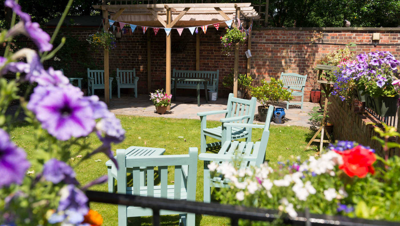 Outdoor garden area with seating and flowers