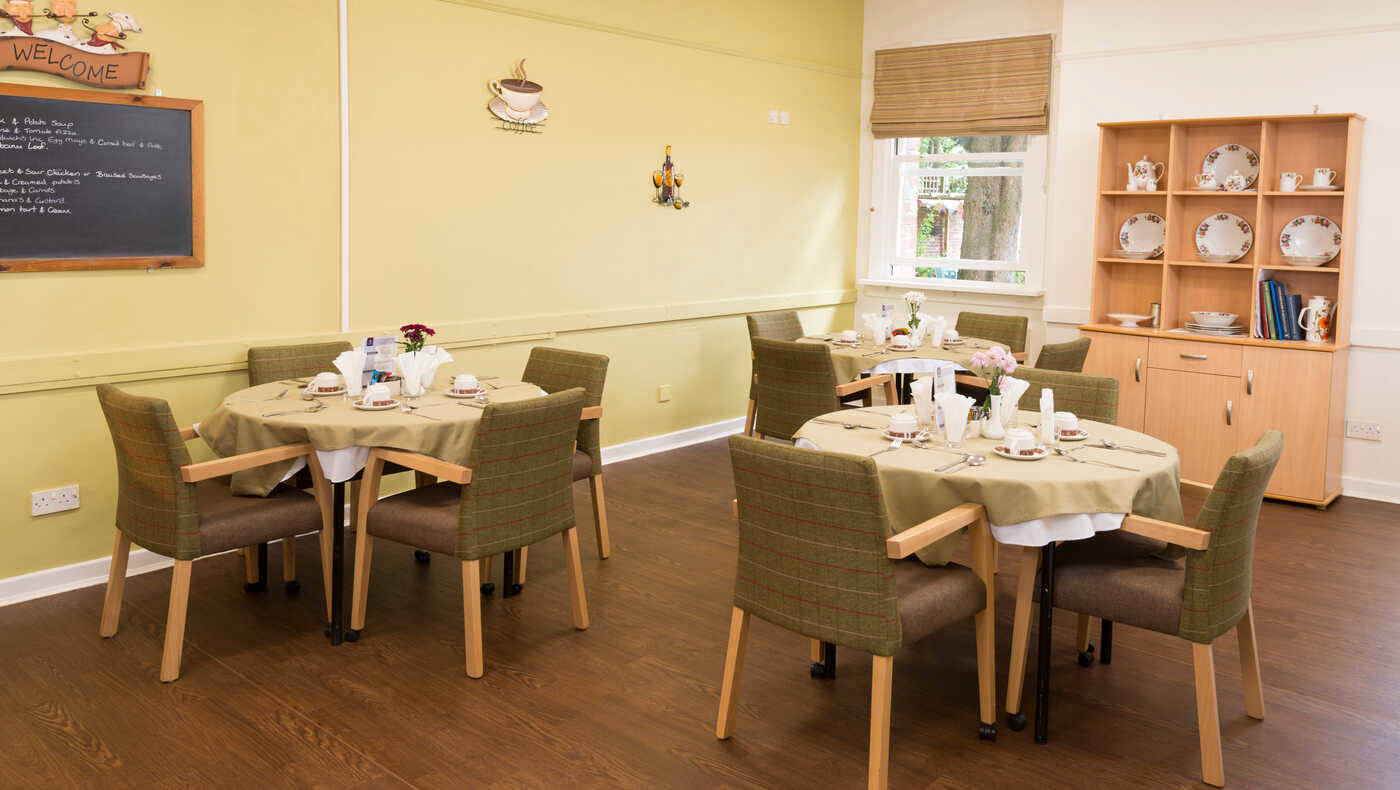 Dining area with neatly set tables and decor