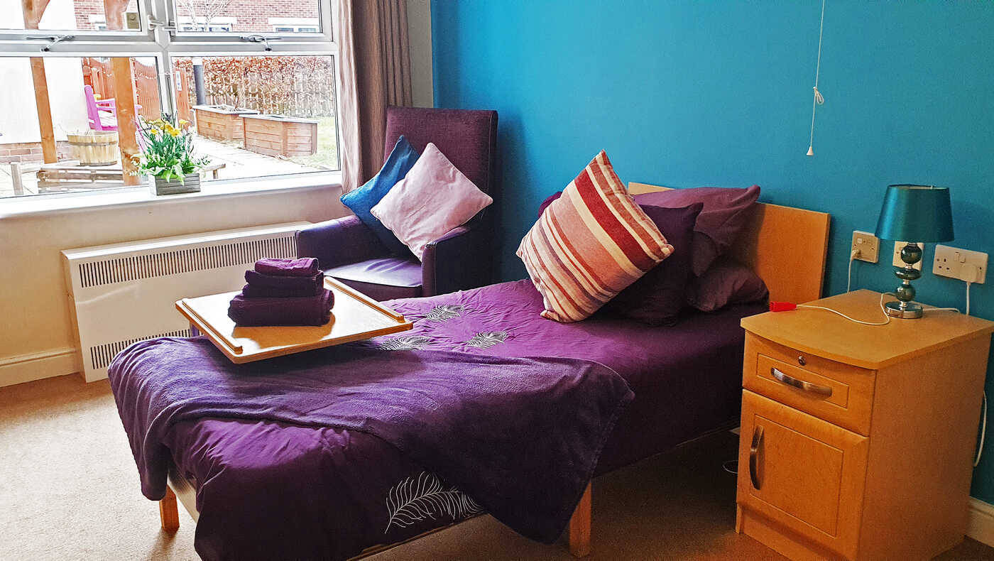 Cozy private resident room with purple decor
