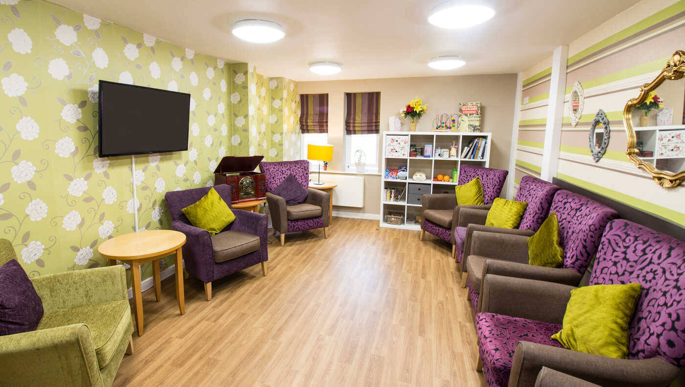 Common area with seating and decor in a senior living facility