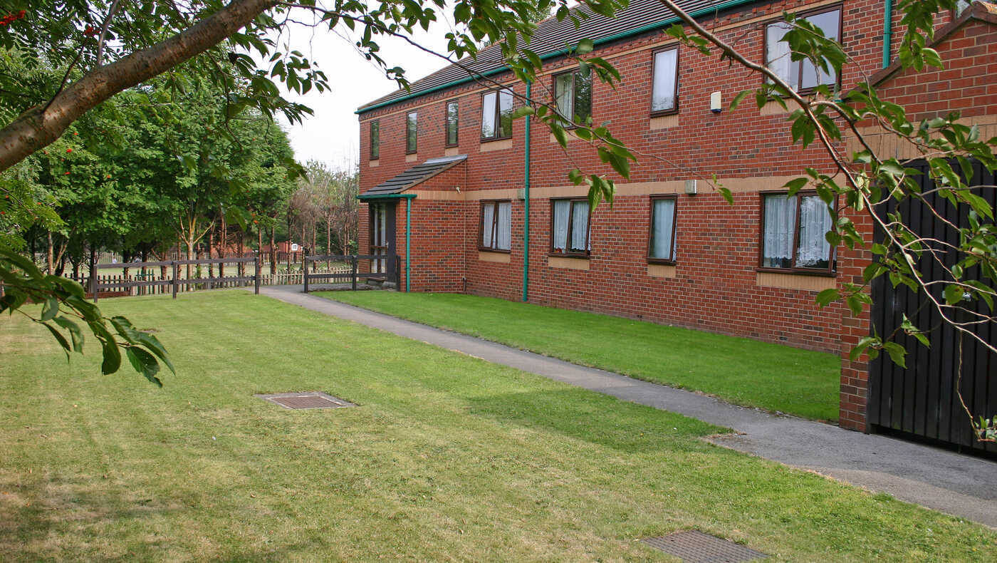 Exterior view of a care facility with green space