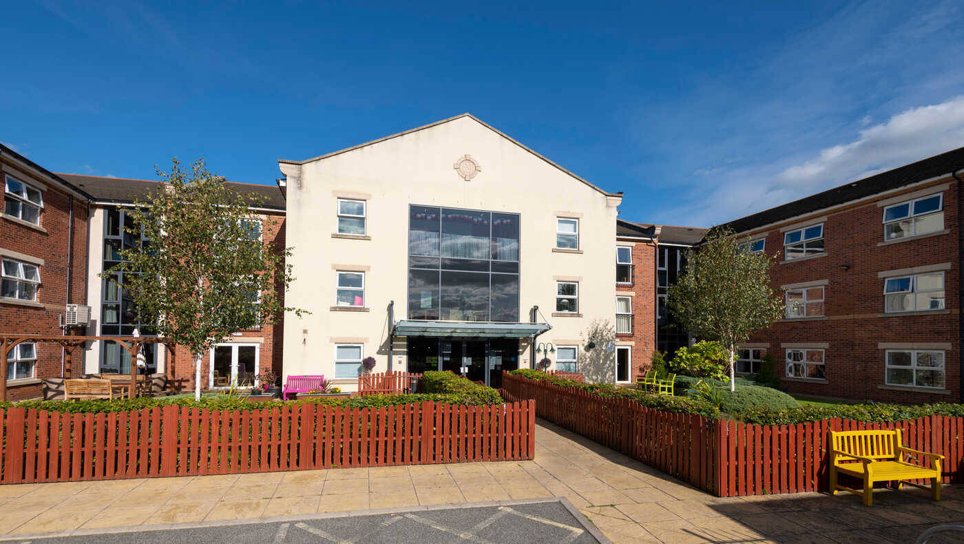 Exterior view of Mill View facility with landscaped gardens