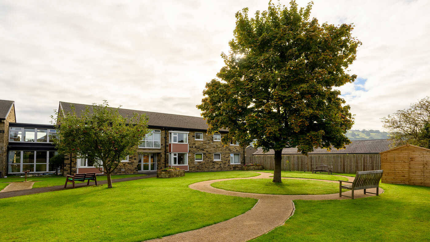 Outdoor area with well-maintained gardens and pathway