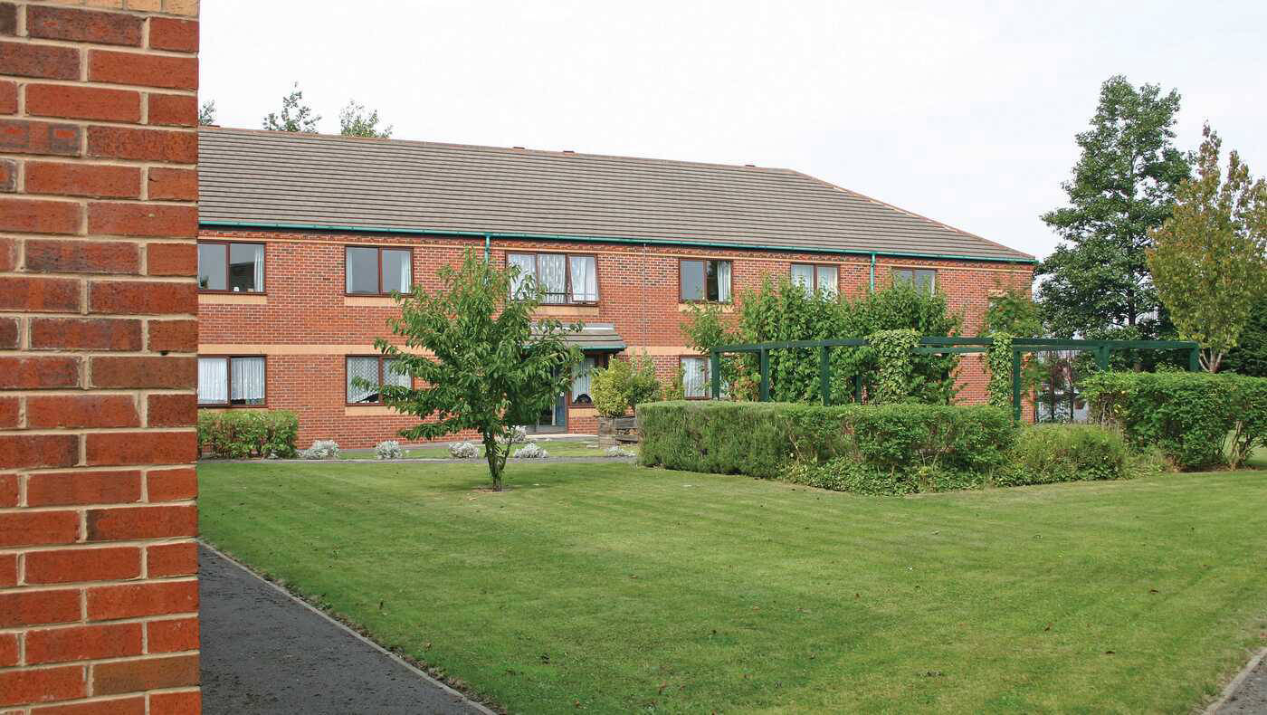 Exterior view of the facility surrounded by gardens