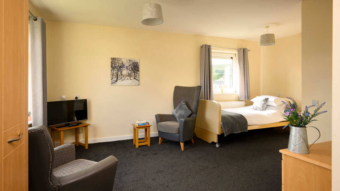 Comfortable resident room with a bed and seating area