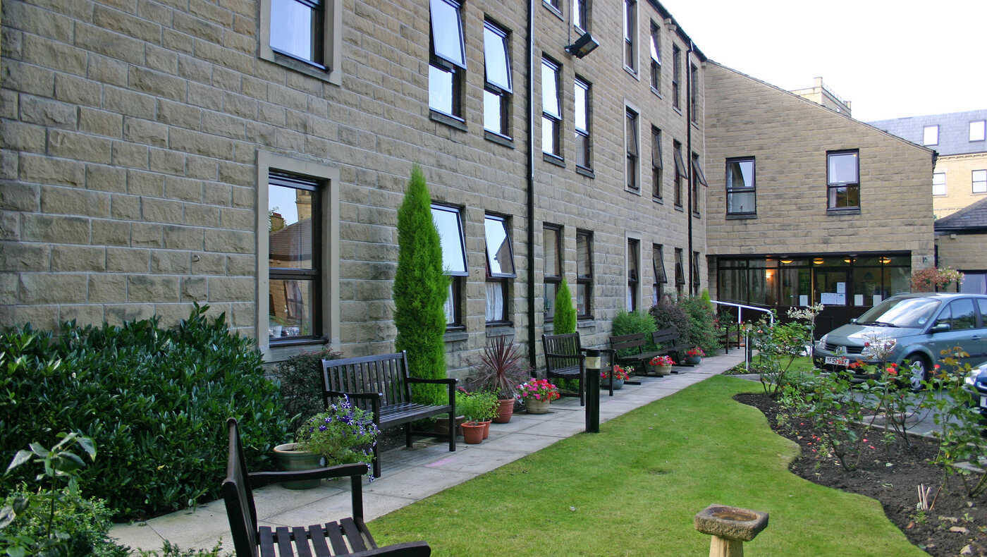 Exterior view of a nursing home facility with garden