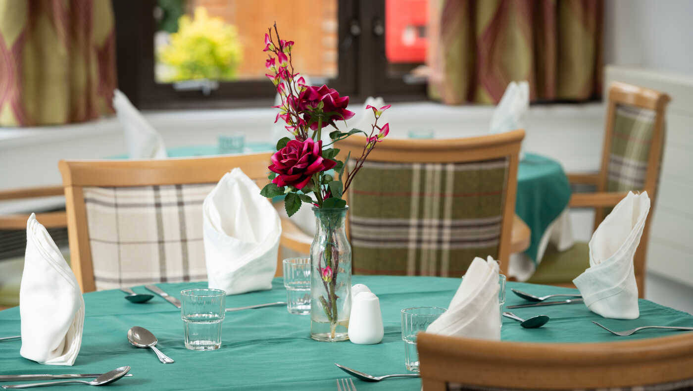 Elegant dining table set up with flowers and napkins