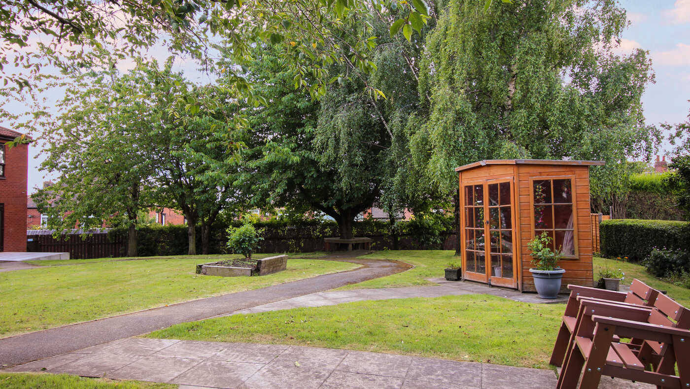 Well-maintained garden with a wooden shed