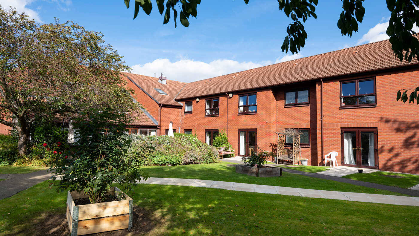 Outdoor space with gardens and building facade