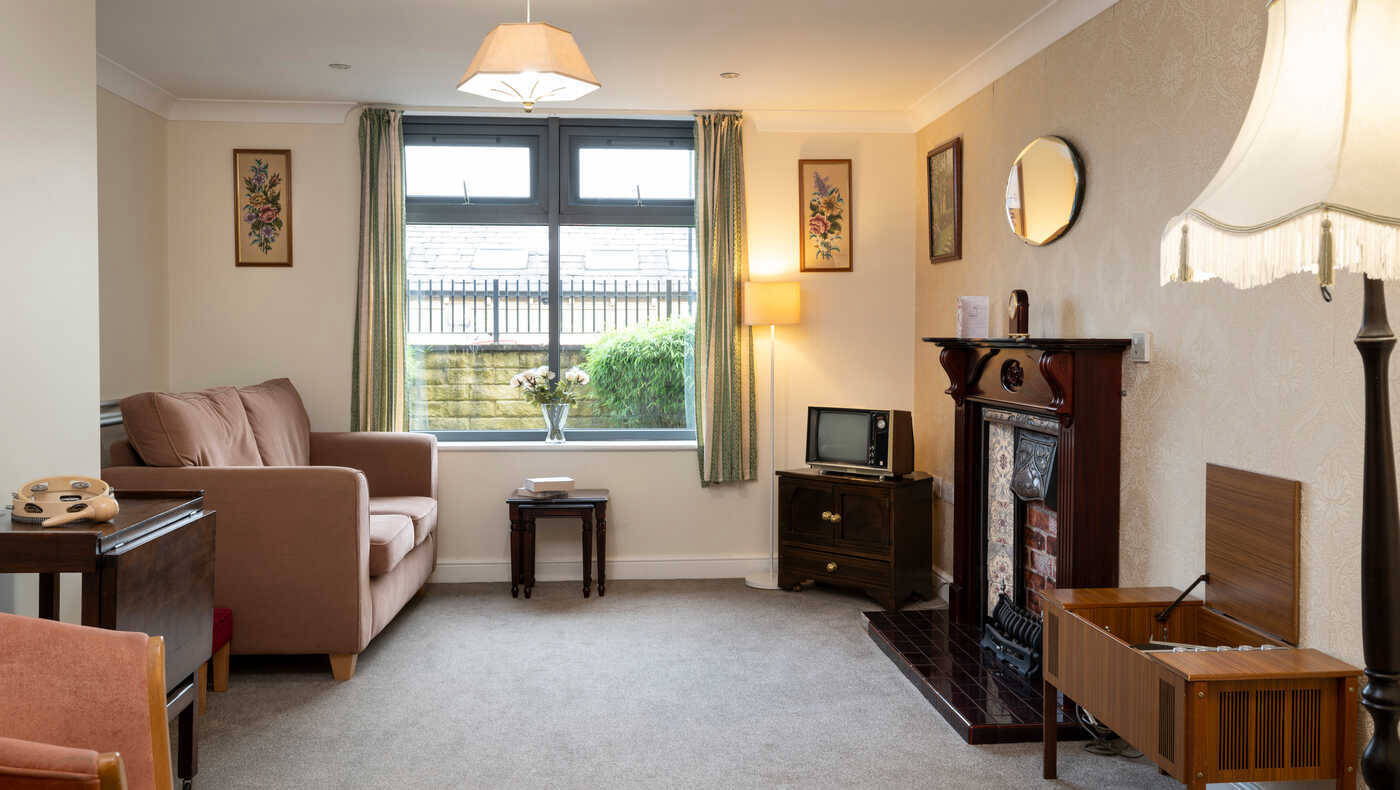 Cozy lounge area with a sofa and lamp