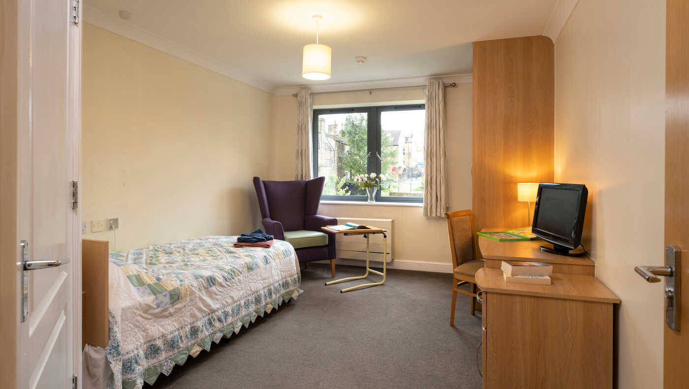 Cozy resident room with a bed and seating area