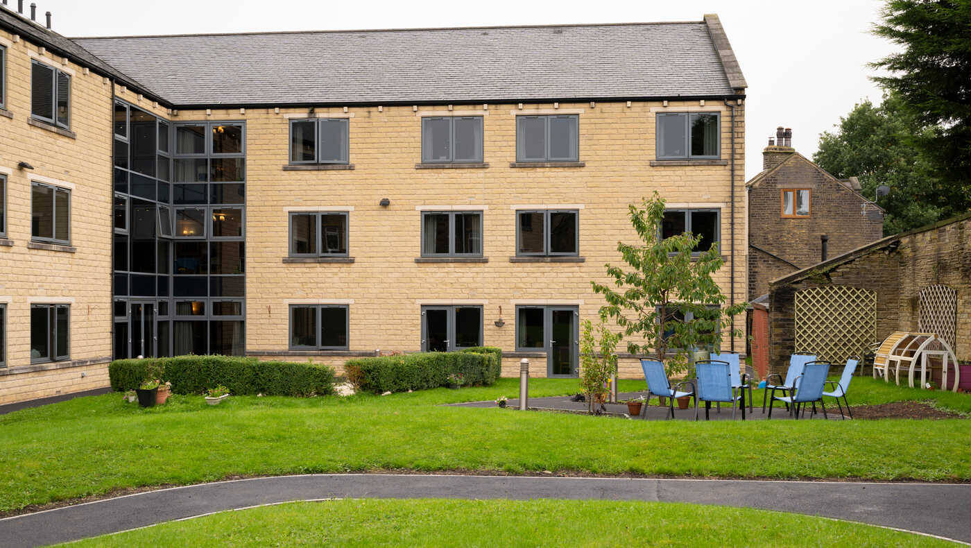 Exterior view of a brick building with outdoor seating