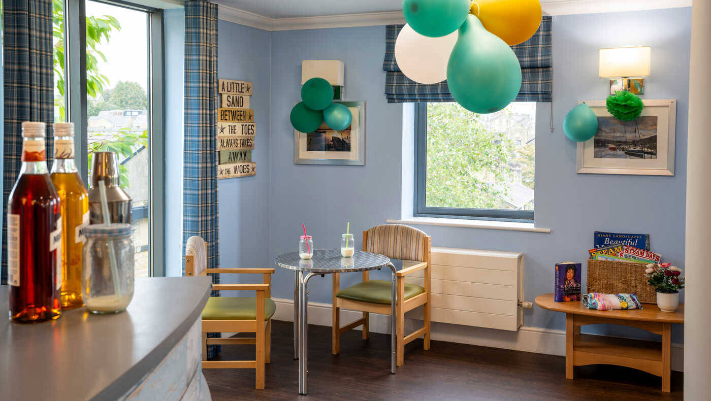 A decorated common area with drinks and festive balloons
