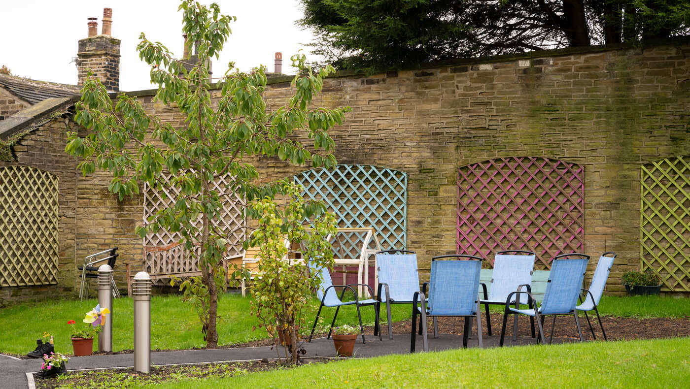 Outdoor seating area with chairs and greenery
