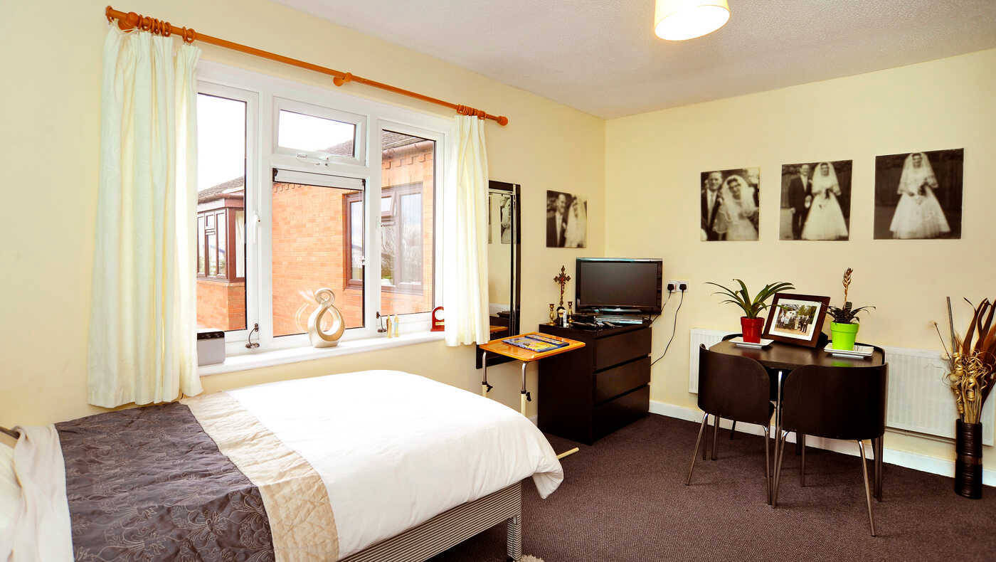 A private room with a bed and small dining area