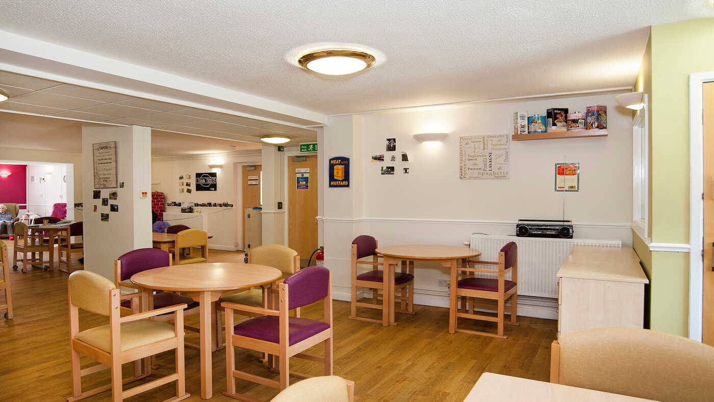 A bright common area with tables and chairs