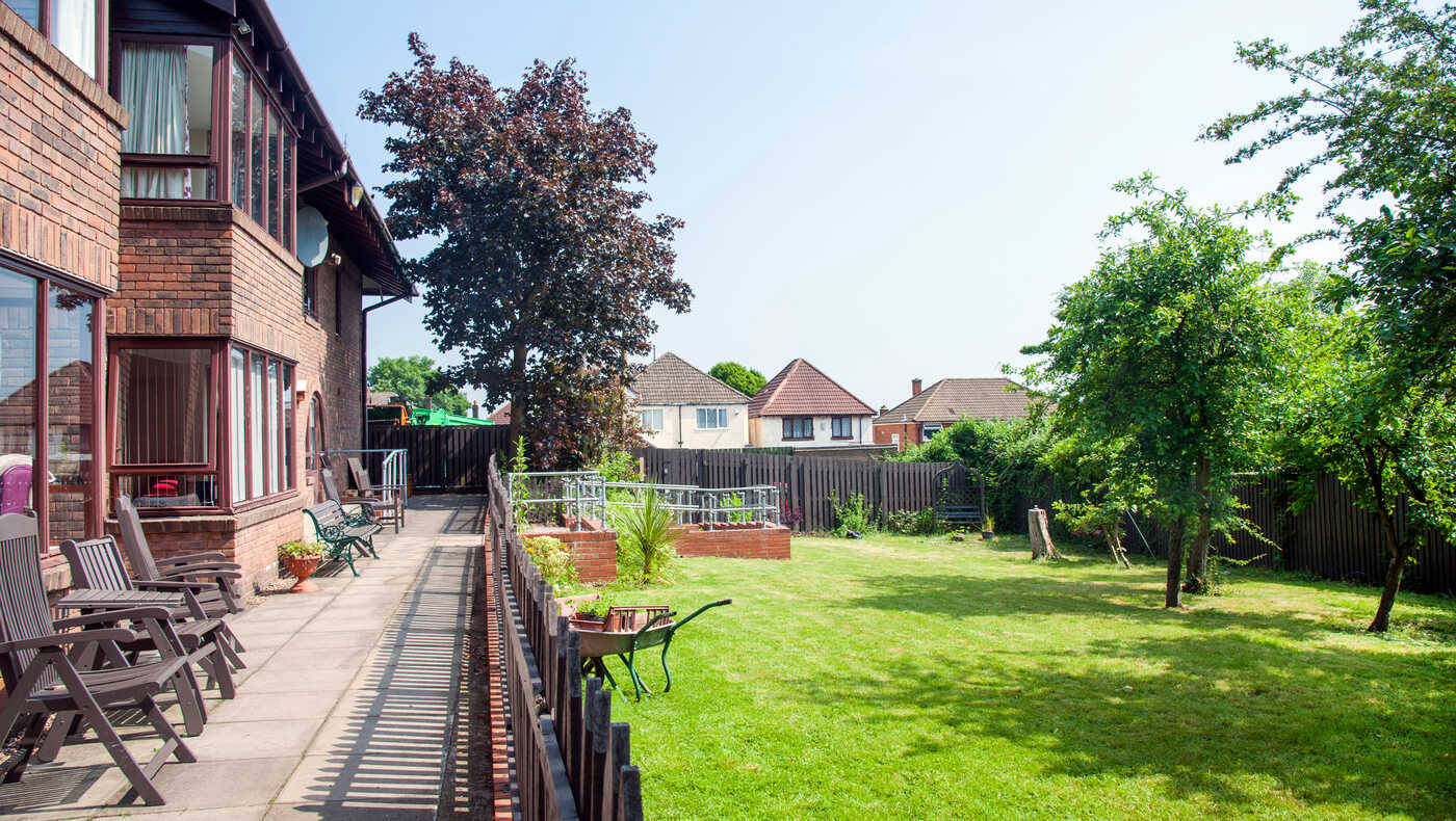 Outdoor space with lawn and seating near the facility