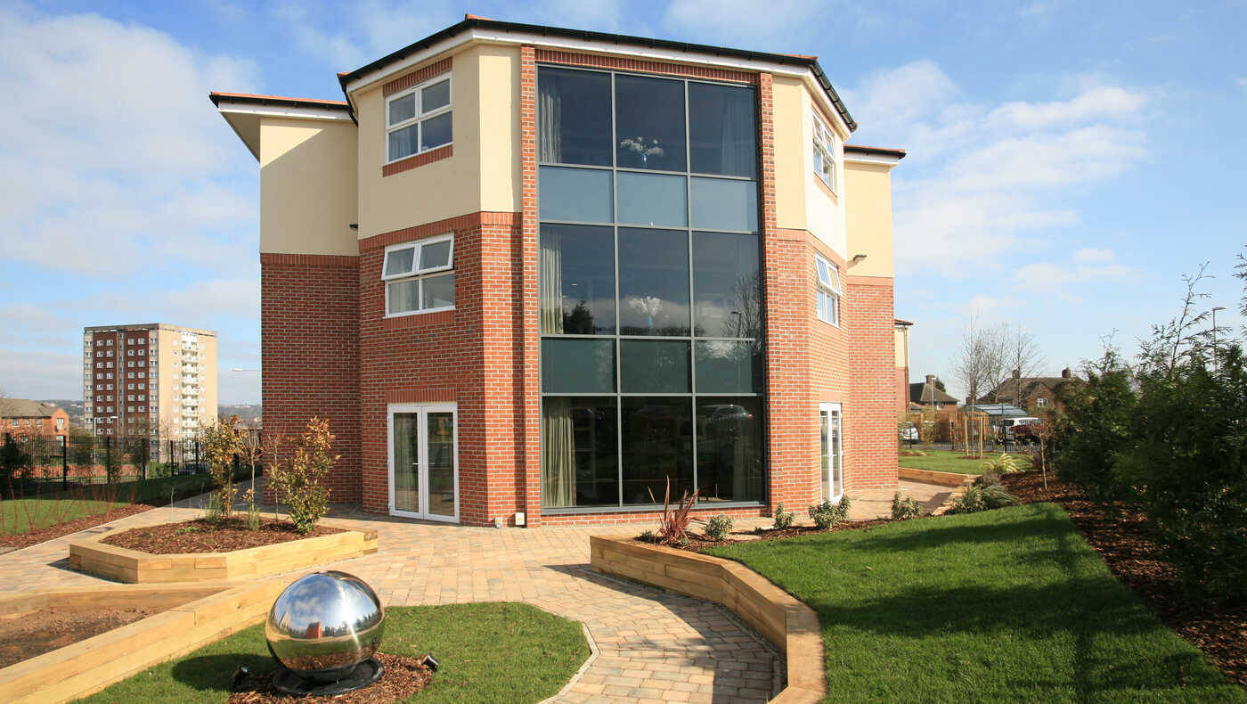 Exterior view of Mill View facility with landscaped garden