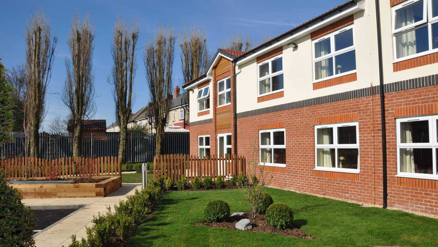 Exterior view of Mill View facility with landscaped garden