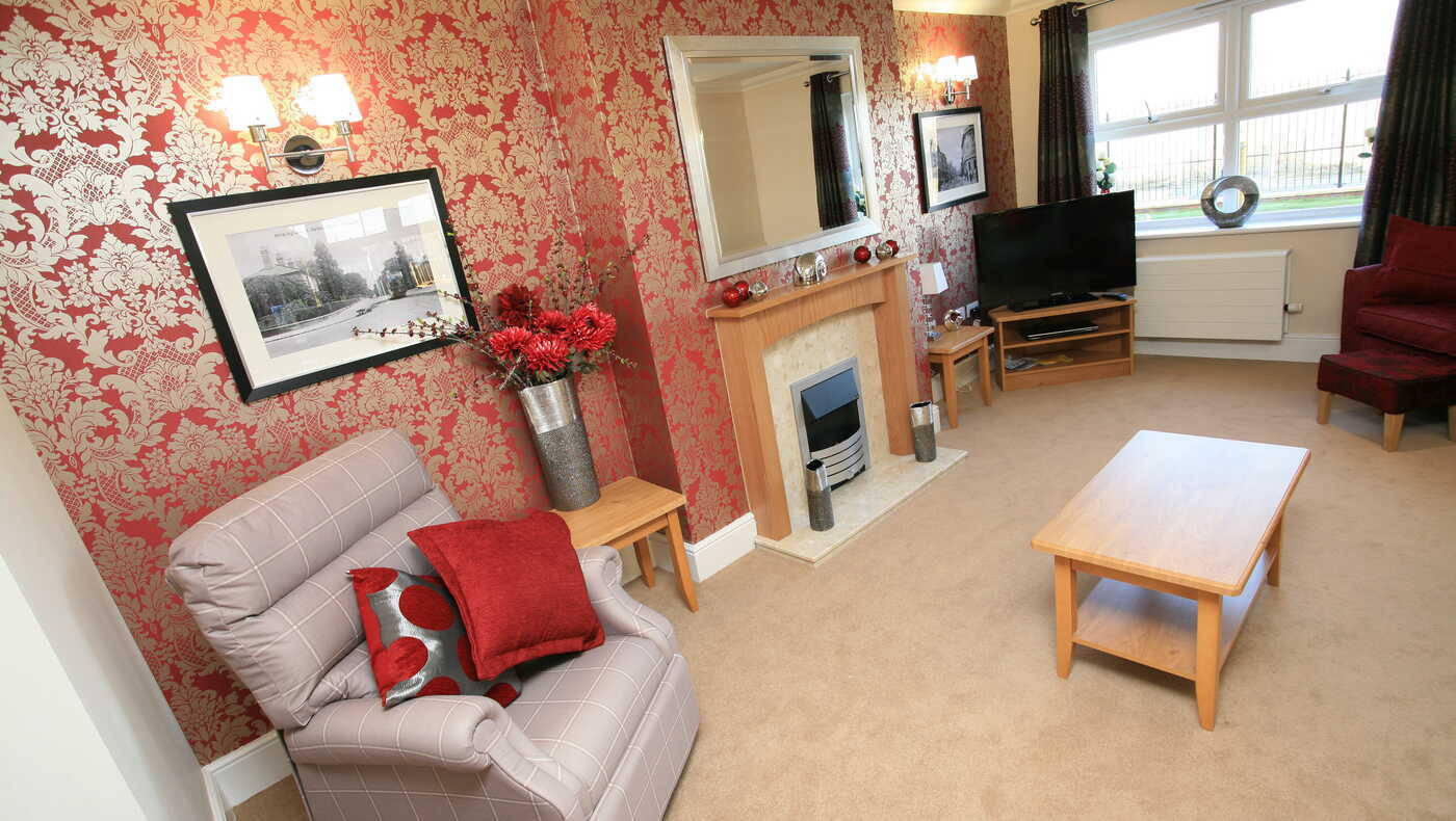 Cozy common area with a decorative wall and comfortable seating.