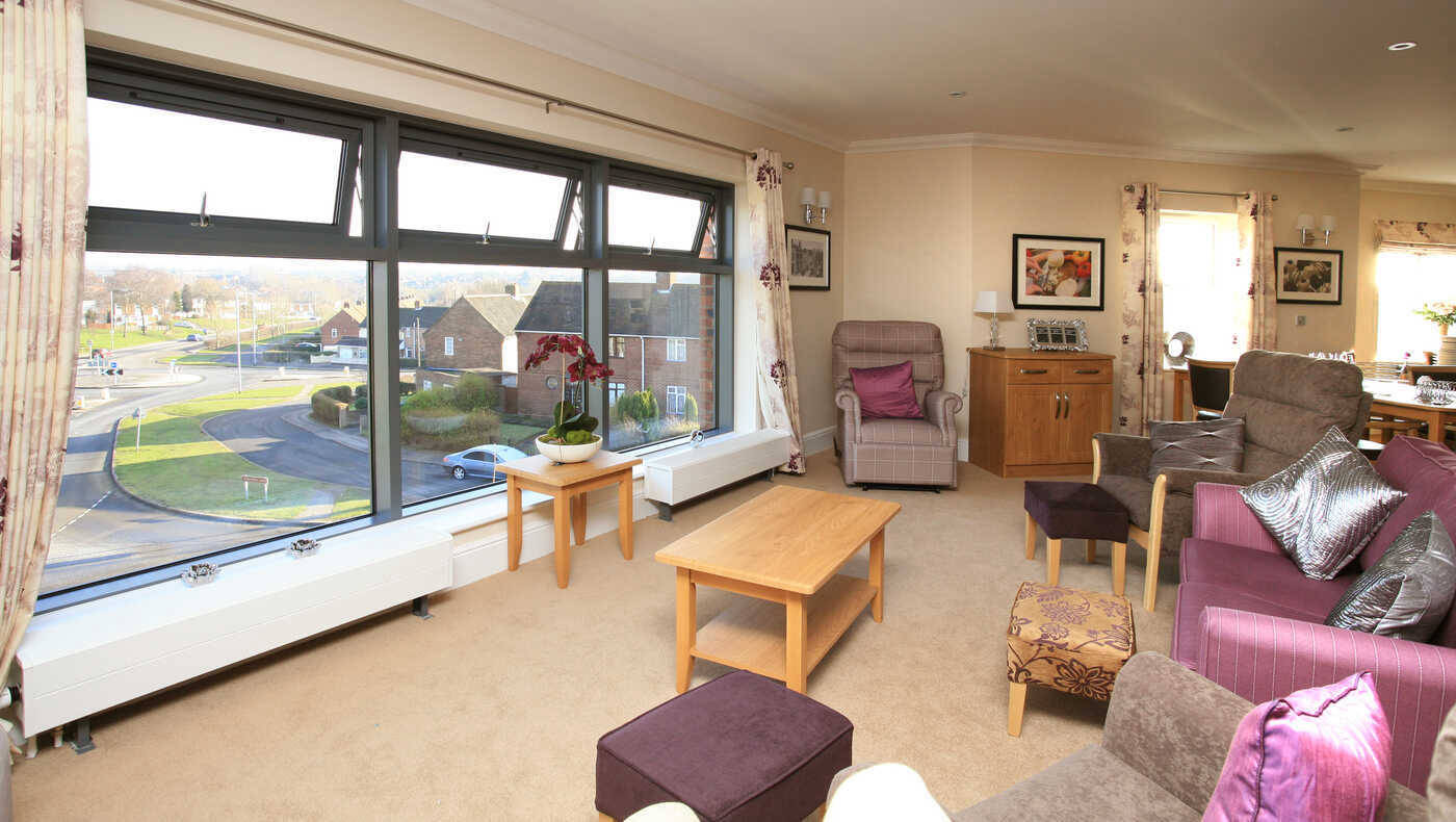 Well-furnished common area with large windows