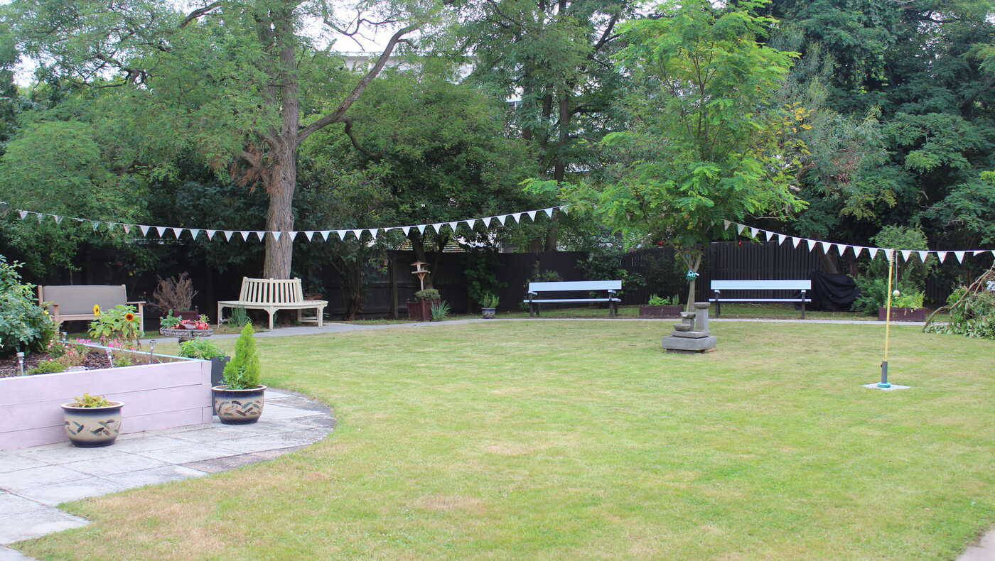 A well-maintained garden area with benches and decorations