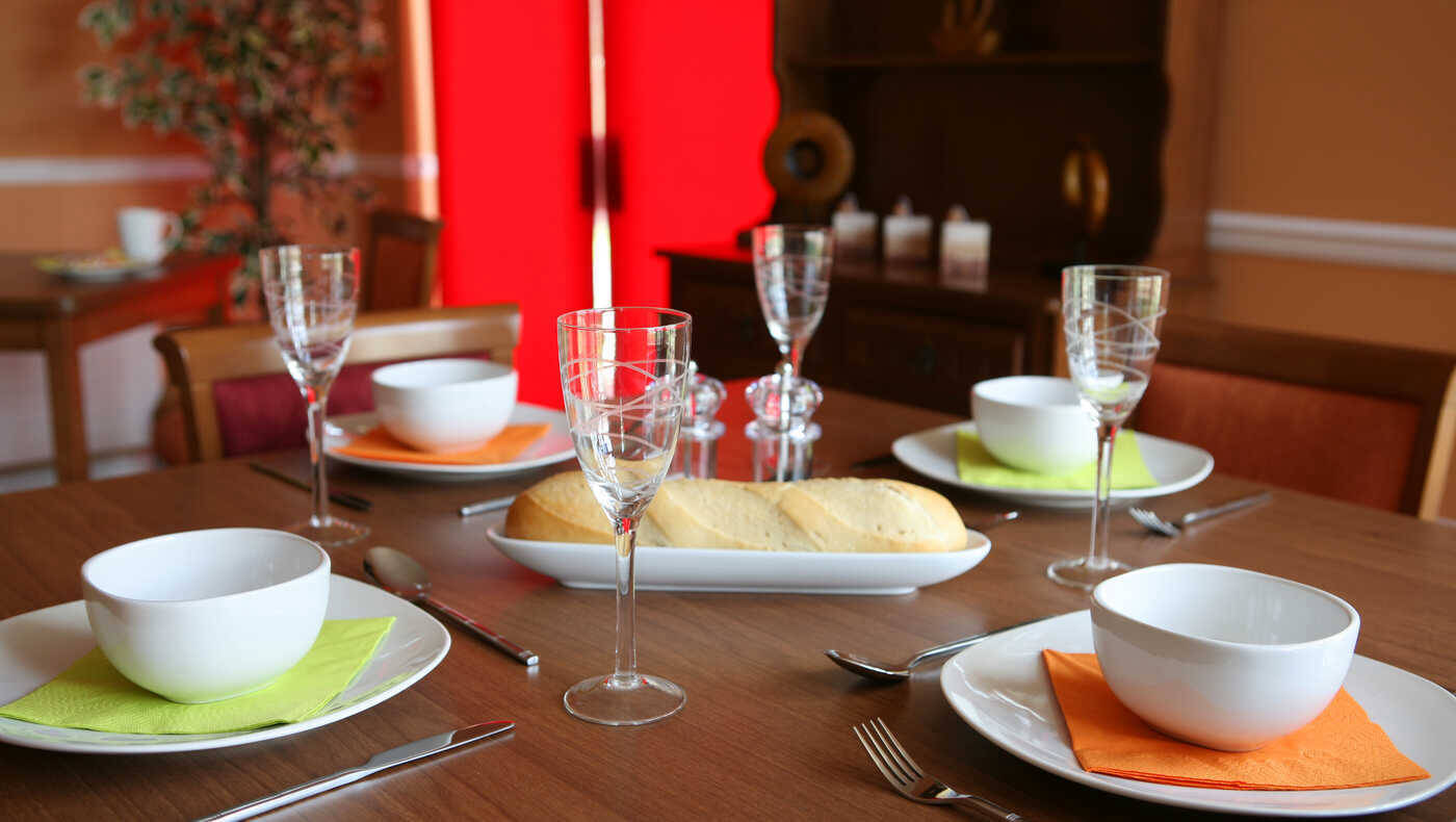 Well-set dining table with bowls and glasses