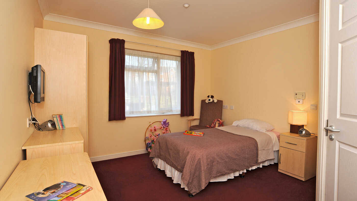 Cozy resident room with a bed and desk