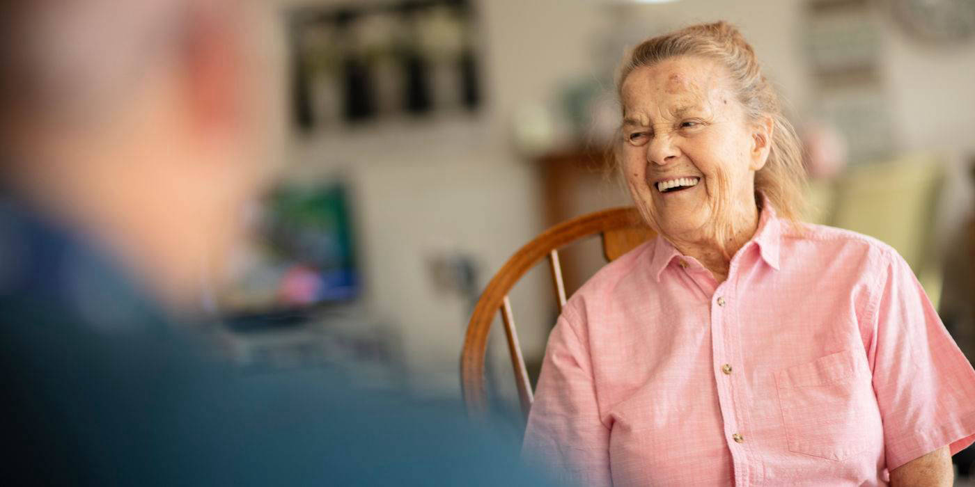 A smiling resident interacting in a common area