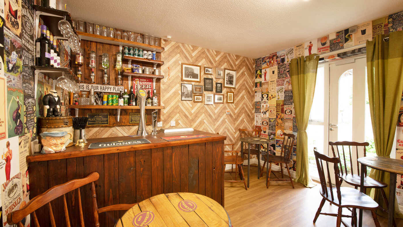 Cozy bar area with wooden decor and vintage posters