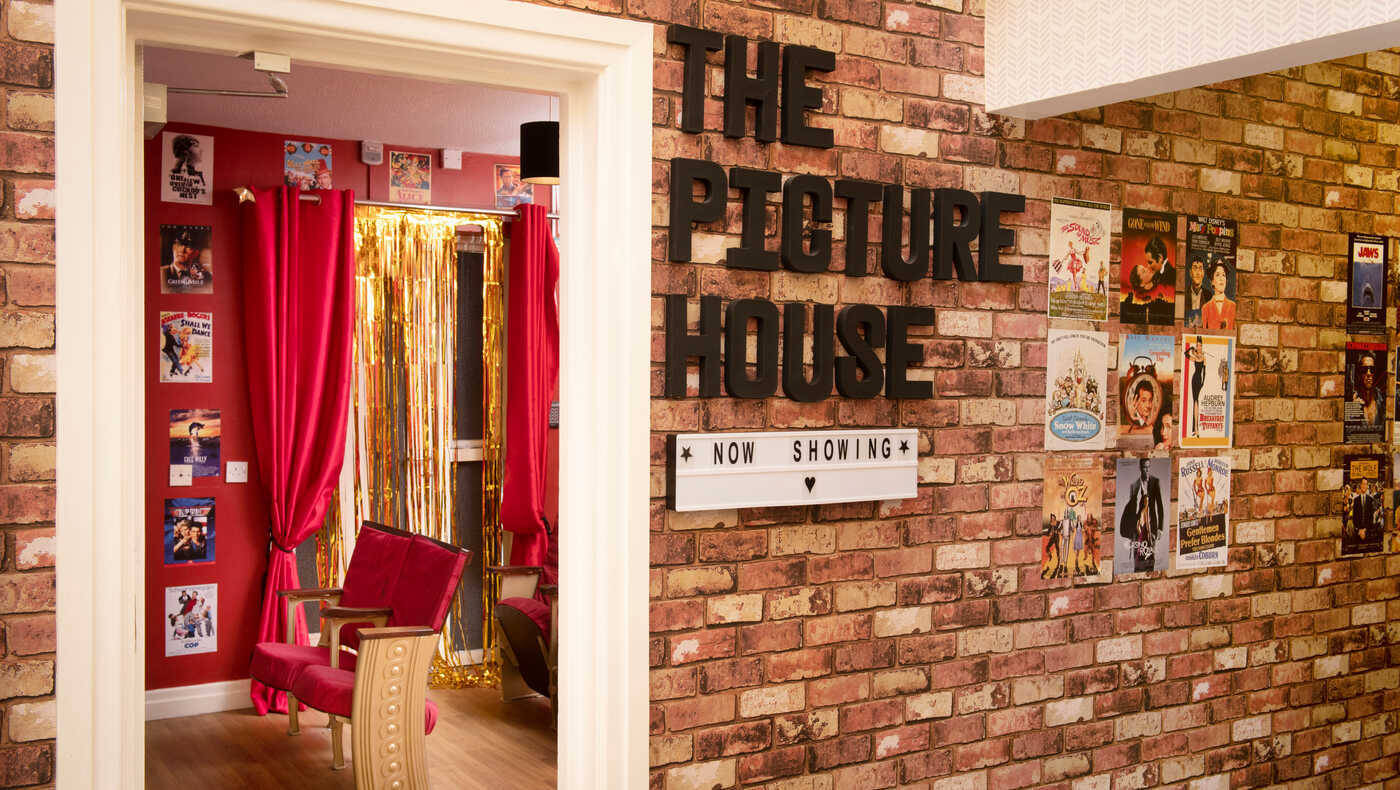 Interior view of a themed common area with movie posters.