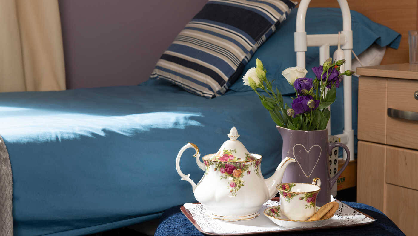 Tea service set with flowers in a bedroom