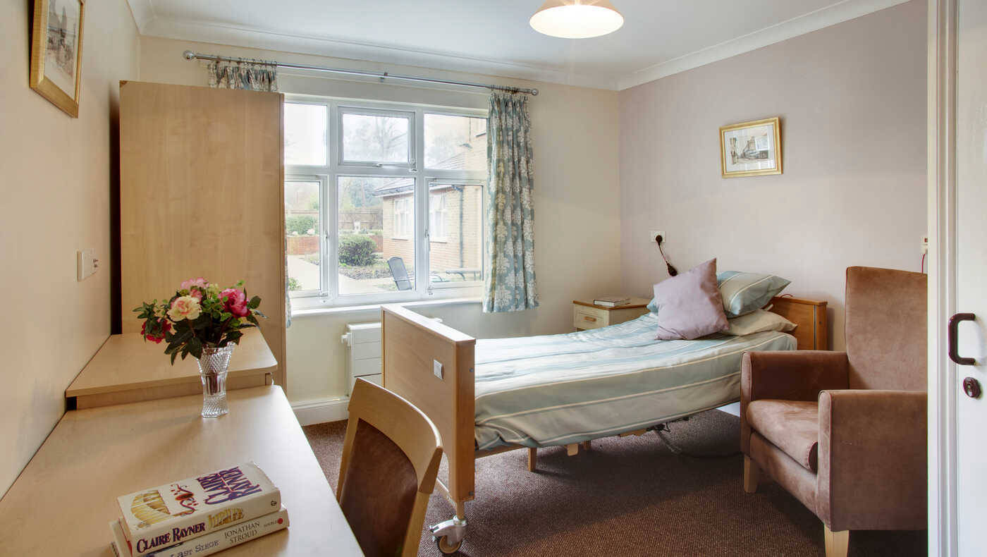 Comfortable private resident room with bed and desk