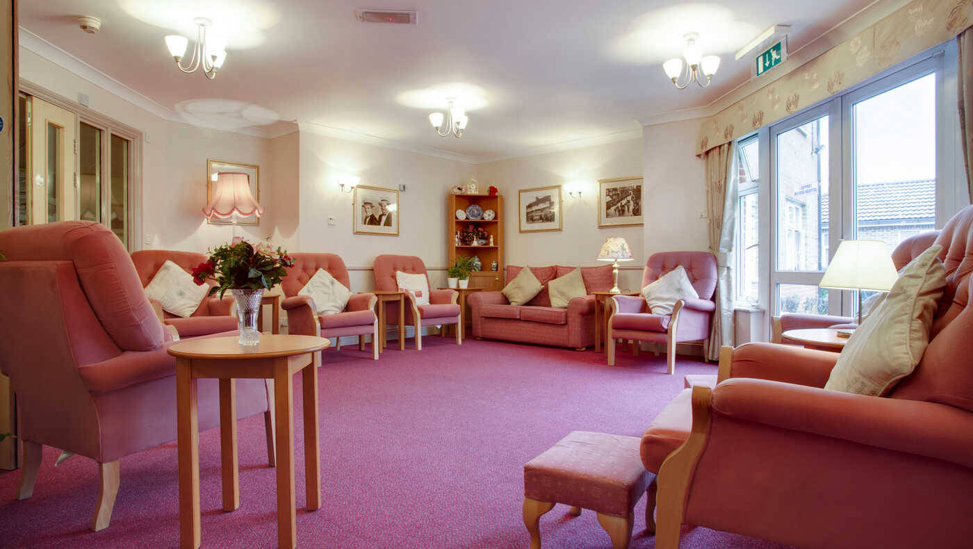 Cozy common area with pink sofas and carpet