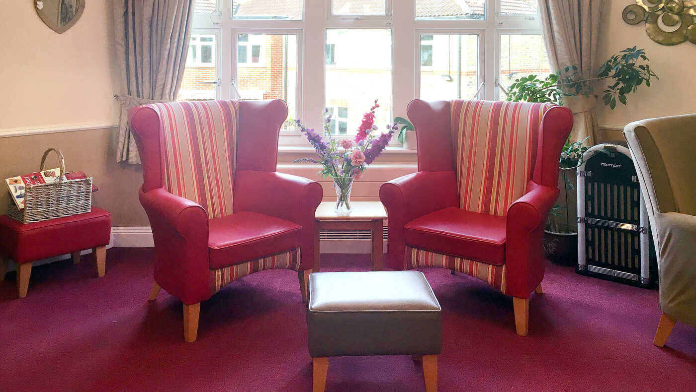 Cozy chairs and a flower vase in a common area