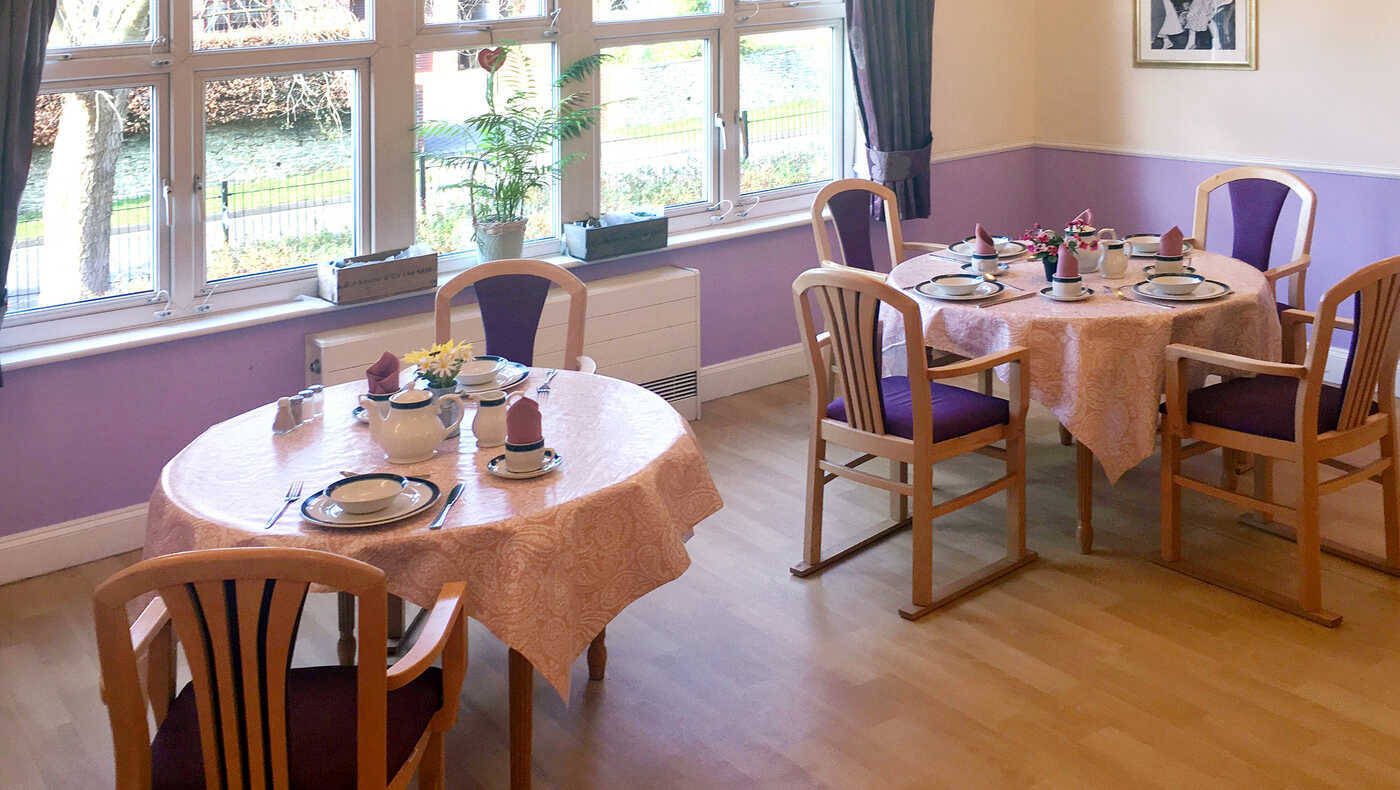 Dining area set with tables and decorations