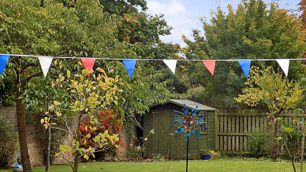 Garden scene with colorful bunting and greenery