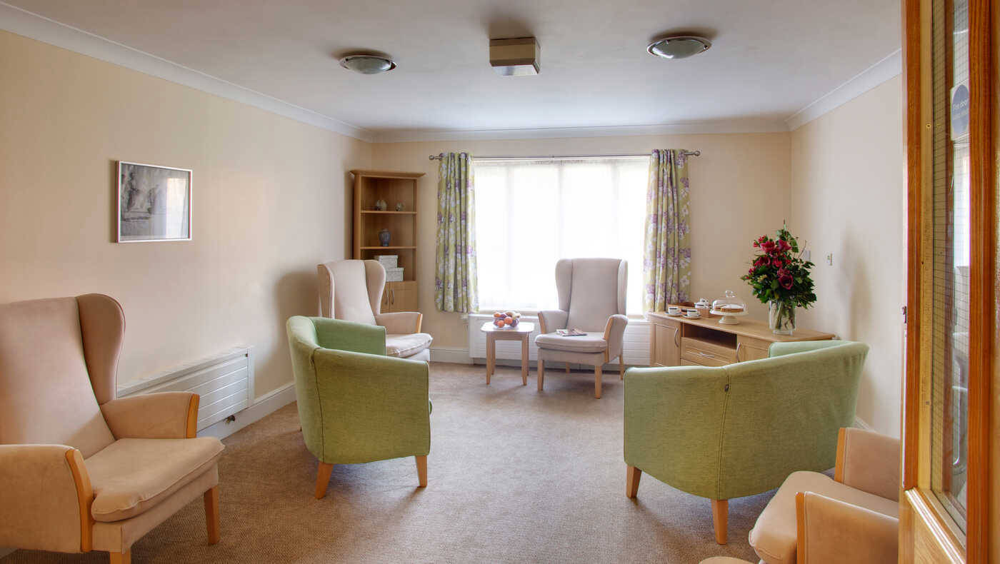 A cozy common area with armchairs and natural light