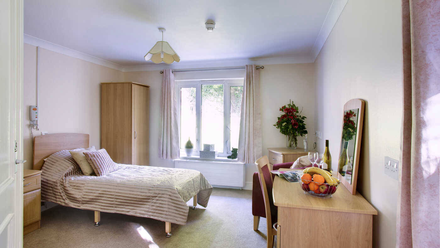 Bright private resident room with decorative fruit arrangement
