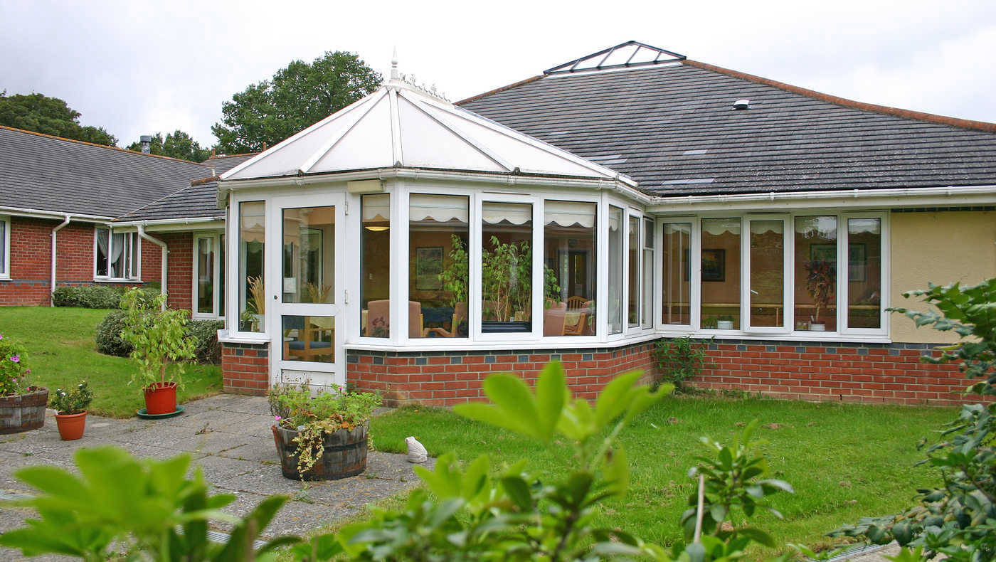 Exterior view of a senior care facility with garden