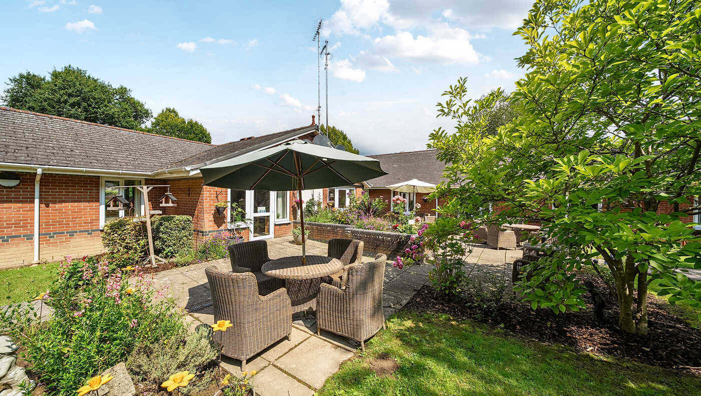 Outdoor seating area with flowers and greenery