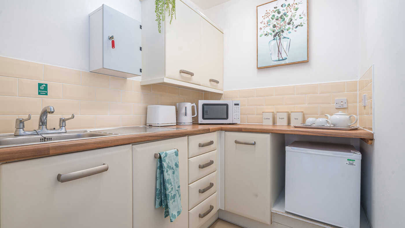 Bright kitchen area with appliances and decor