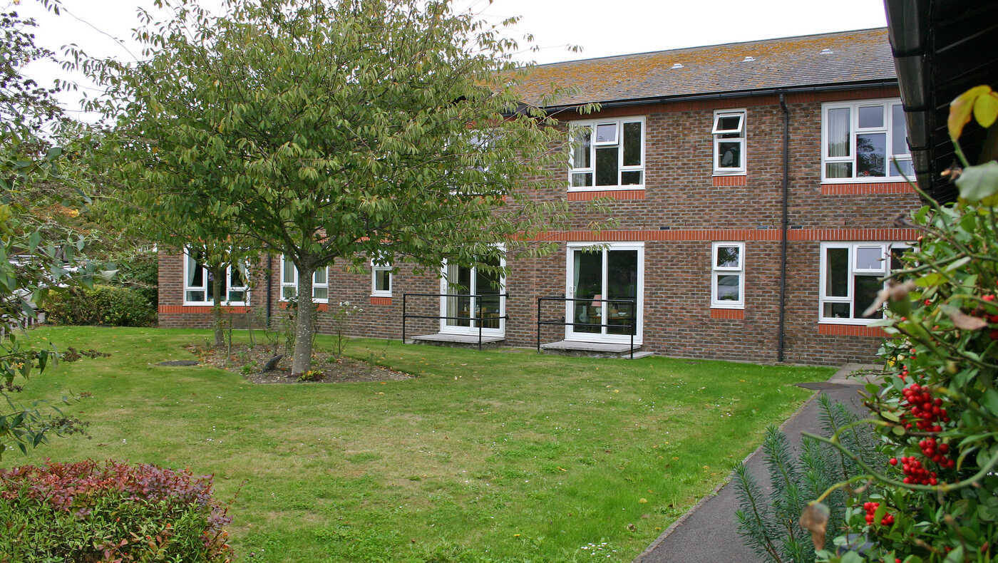 Exterior view of a senior living facility with greenery