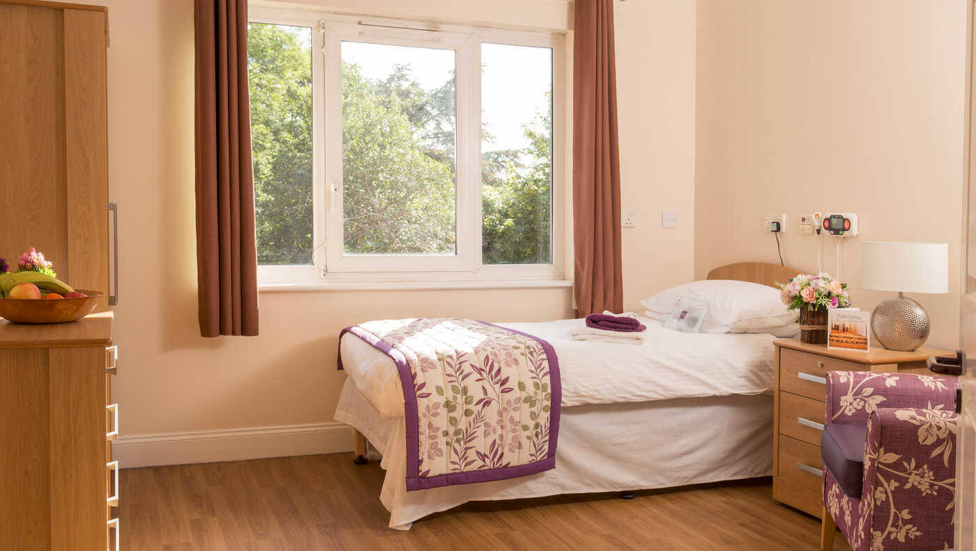 Cozy resident room with a bed and window view